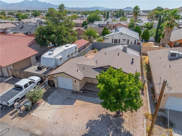 birds eye view of property with a mountain view and a residential view