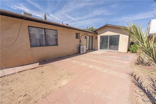 back of property featuring ac unit, a patio, and stucco siding