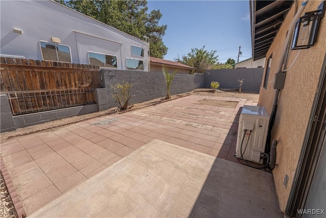 view of patio featuring ac unit and a fenced backyard