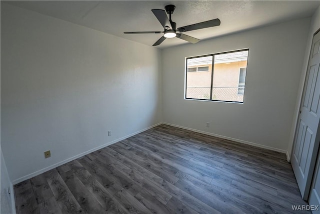 unfurnished bedroom with a closet, dark wood-style flooring, and baseboards