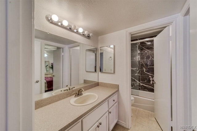 bathroom featuring shower / bathing tub combination, a textured ceiling, tile patterned flooring, vanity, and toilet