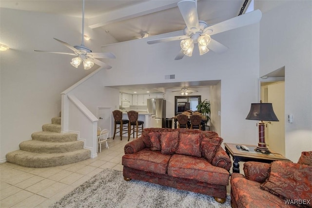 living room with high vaulted ceiling, ceiling fan, and light tile patterned floors