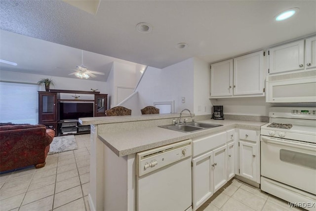 kitchen featuring a sink, light tile patterned floors, a peninsula, open floor plan, and white appliances
