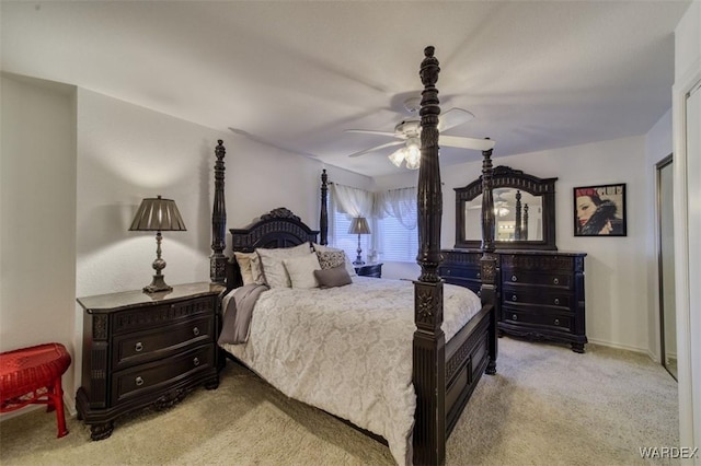 bedroom featuring light colored carpet and a ceiling fan