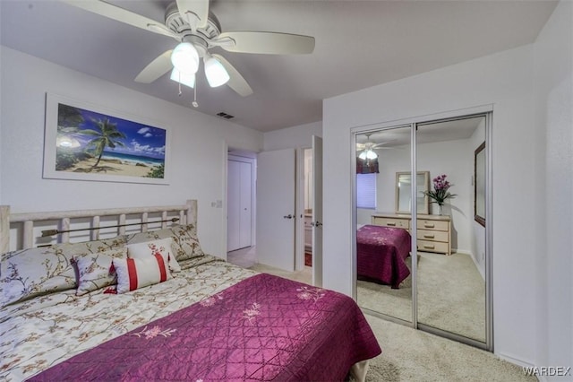 bedroom with a closet, carpet, ceiling fan, and visible vents