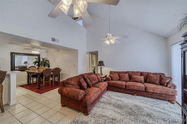 living room with visible vents, a ceiling fan, light tile patterned flooring, and high vaulted ceiling