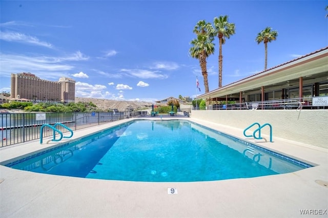view of swimming pool with fence