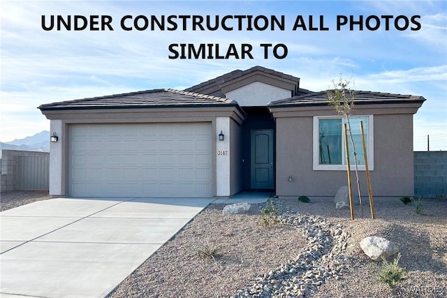 single story home with an attached garage, stucco siding, and concrete driveway
