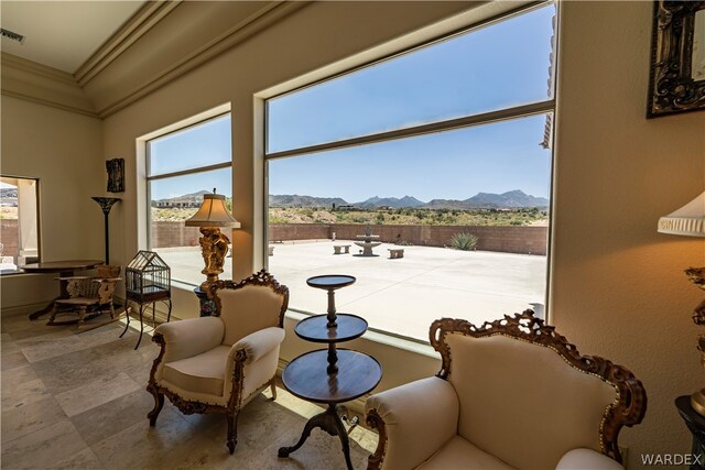 living area featuring visible vents, ornamental molding, and a mountain view