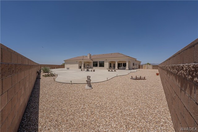 back of property featuring a patio, a tile roof, a fenced backyard, and stucco siding