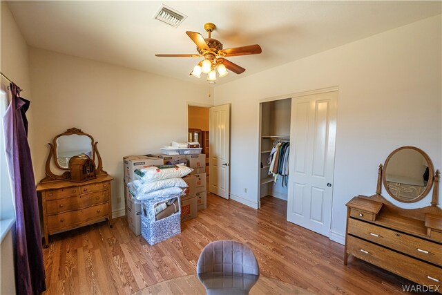 bedroom with ceiling fan, light wood finished floors, a closet, and visible vents