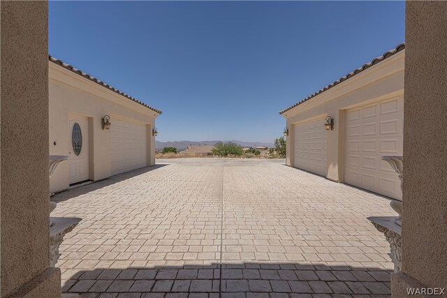 view of patio / terrace featuring decorative driveway and a mountain view