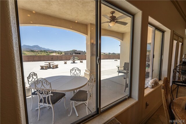 doorway to outside featuring a mountain view and ceiling fan