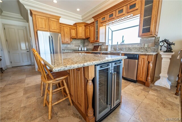 kitchen featuring stainless steel fridge, beverage cooler, brown cabinetry, a kitchen island, and glass insert cabinets