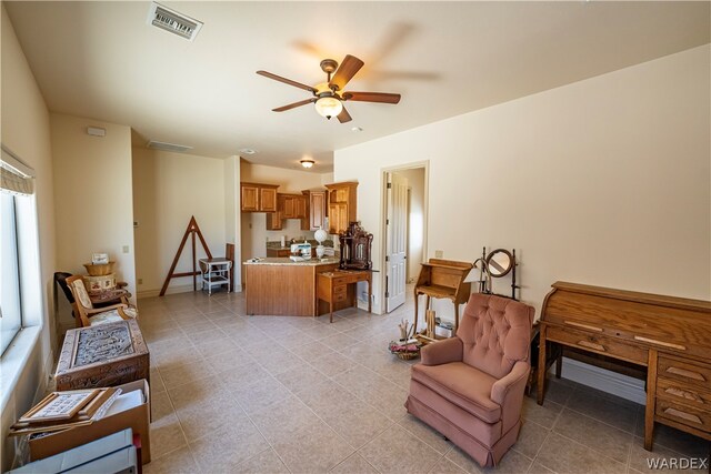 interior space featuring ceiling fan, light tile patterned floors, visible vents, and baseboards