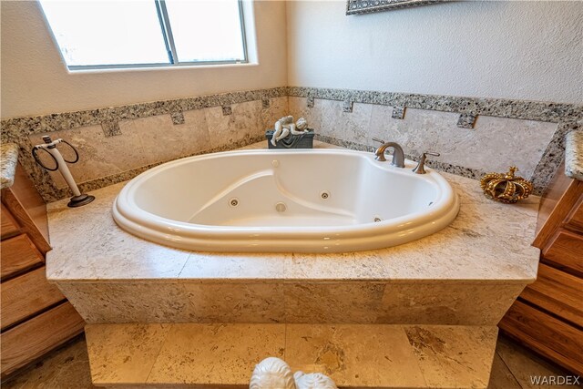 full bathroom with a jetted tub