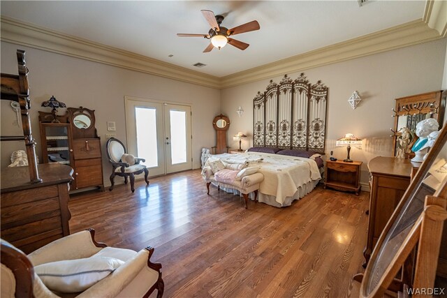 bedroom featuring ornamental molding, access to outside, french doors, and wood finished floors