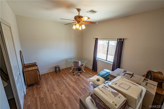 interior space featuring baseboards, visible vents, a ceiling fan, washer and dryer, and light wood-type flooring