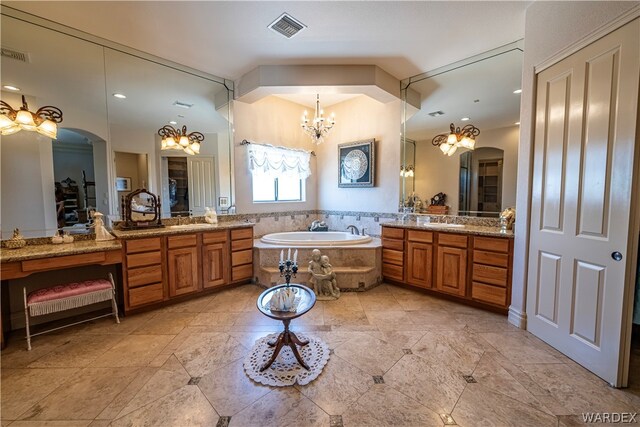 full bath with a garden tub, two vanities, a sink, and visible vents