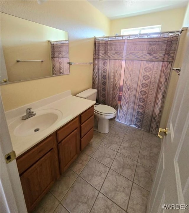 full bath featuring toilet, tile patterned flooring, and vanity