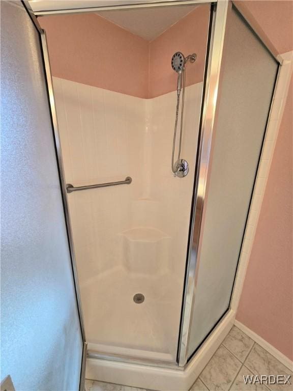 bathroom featuring a stall shower and tile patterned floors