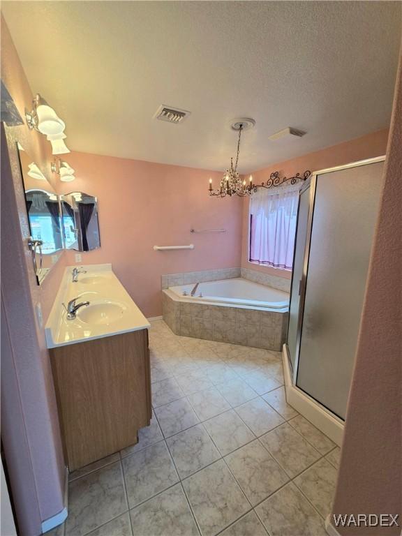 bathroom featuring a garden tub, visible vents, a stall shower, a textured ceiling, and a chandelier