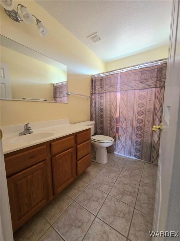 bathroom featuring toilet, visible vents, vanity, and tile patterned floors