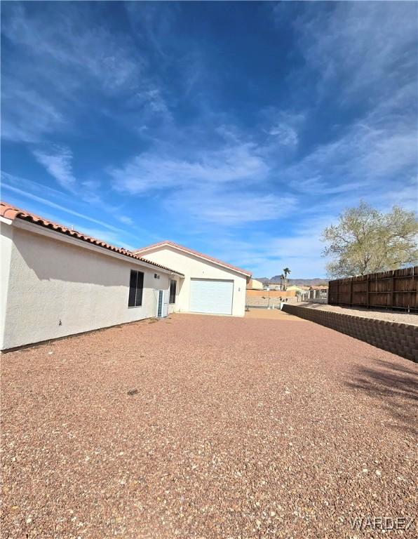 exterior space with fence and stucco siding