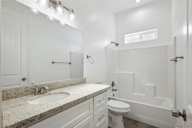 full bathroom featuring toilet, vanity, wood finished floors, and bathing tub / shower combination