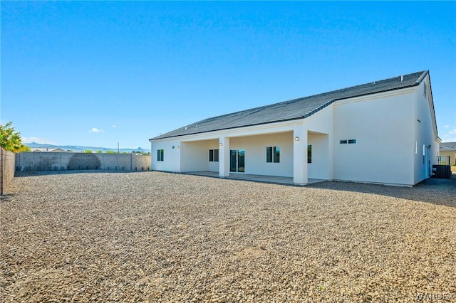 back of property featuring fence private yard, a patio area, a mountain view, and stucco siding