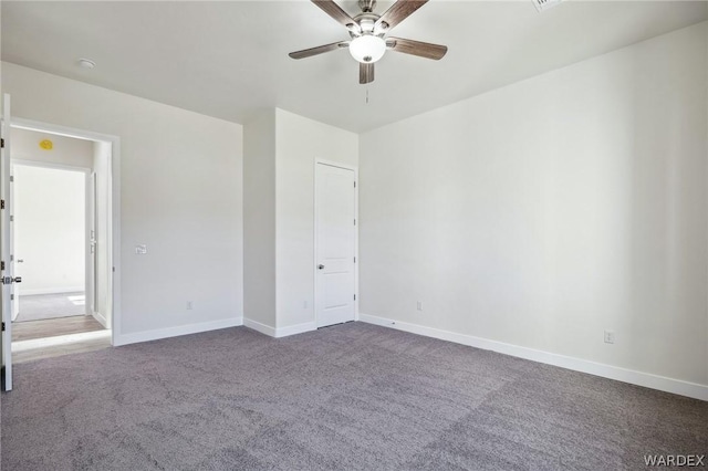 unfurnished bedroom featuring carpet, a ceiling fan, and baseboards