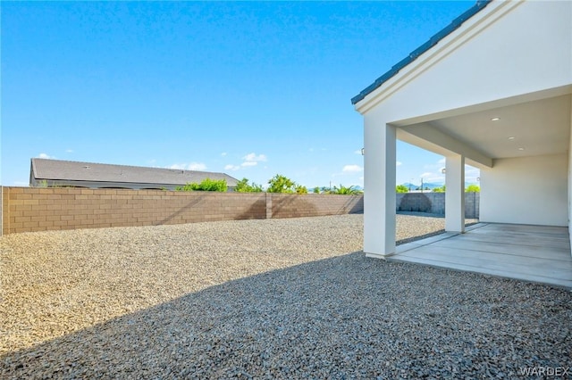 view of yard with a patio area and a fenced backyard