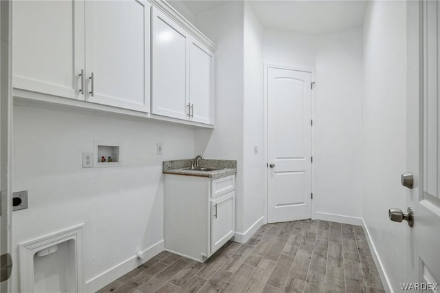 laundry area featuring light wood-style flooring, washer hookup, a sink, cabinet space, and electric dryer hookup