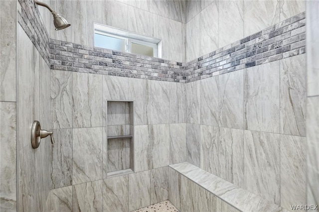 full bathroom featuring tiled shower