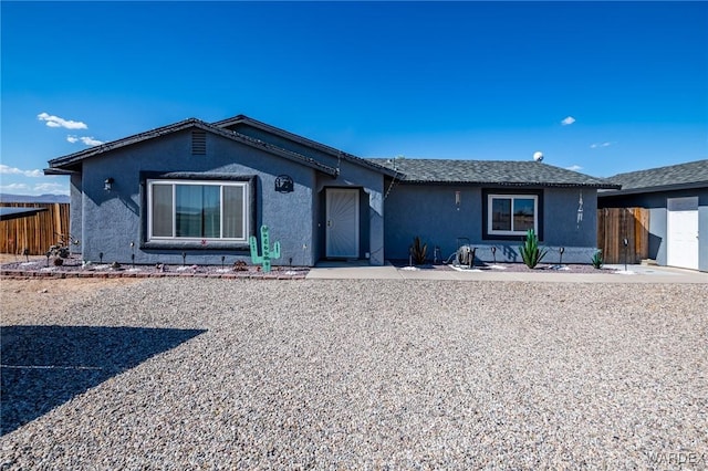 single story home with fence and stucco siding