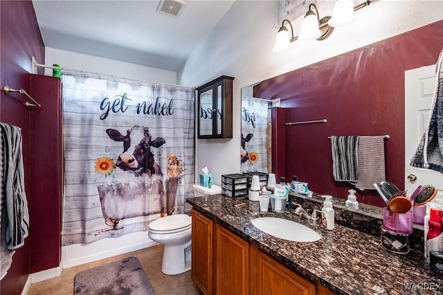 bathroom featuring tile patterned flooring, toilet, vanity, visible vents, and shower / bath combo with shower curtain