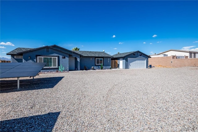 ranch-style home with fence and an attached garage