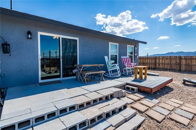 view of patio featuring fence and a mountain view