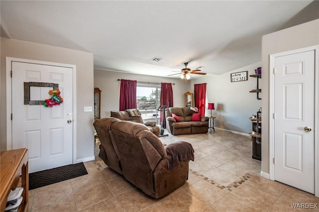 living area featuring light tile patterned floors, a ceiling fan, visible vents, and baseboards