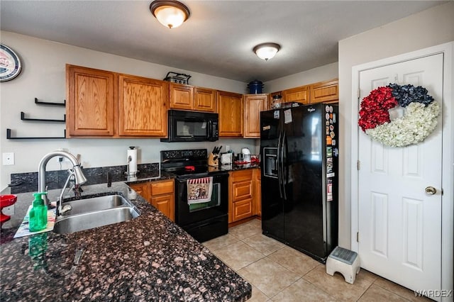 kitchen with light tile patterned flooring, open shelves, a sink, black appliances, and brown cabinetry