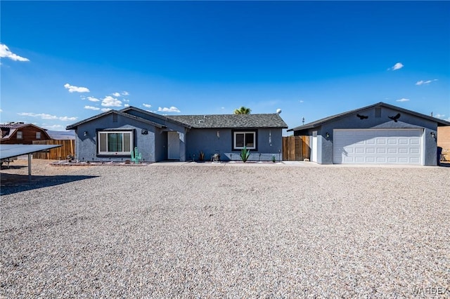 ranch-style home featuring a garage, fence, and stucco siding