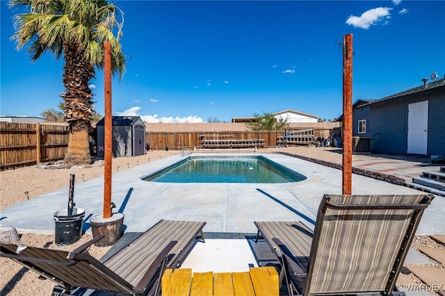 view of pool with a storage shed, a fenced in pool, a patio, a fenced backyard, and an outdoor structure