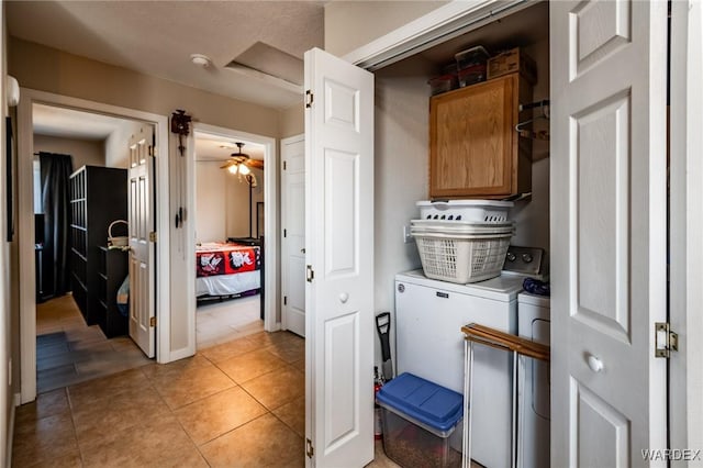 laundry room with cabinet space, washer and clothes dryer, and light tile patterned flooring