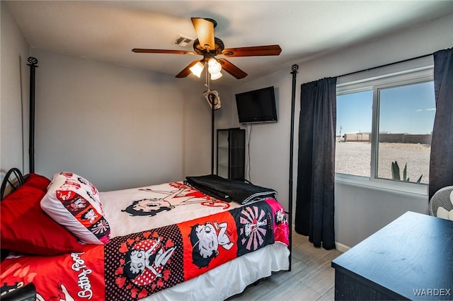 bedroom featuring baseboards, visible vents, and a ceiling fan