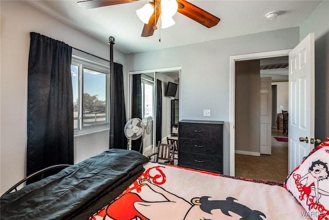 tiled bedroom with a ceiling fan, visible vents, and baseboards