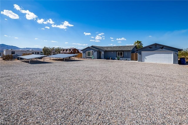 ranch-style house featuring a garage, driveway, and a mountain view