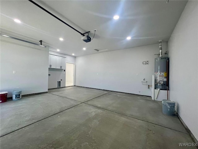 garage featuring water heater and a garage door opener