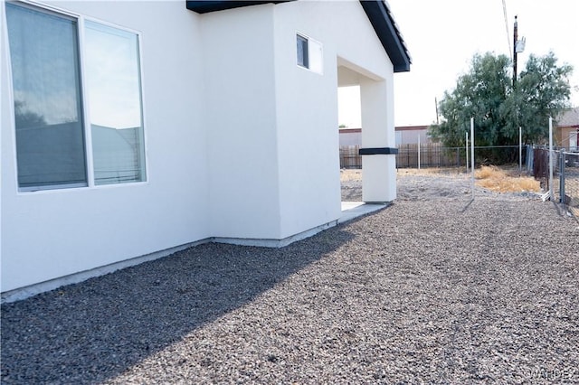 view of home's exterior featuring fence and stucco siding