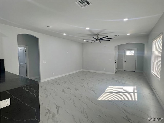 interior space with arched walkways, recessed lighting, visible vents, baseboards, and marble finish floor