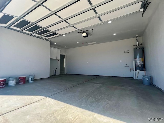 garage featuring water heater and a garage door opener